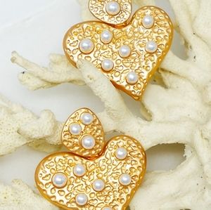 Gold heart shape hammered metal earrings with pearls.
